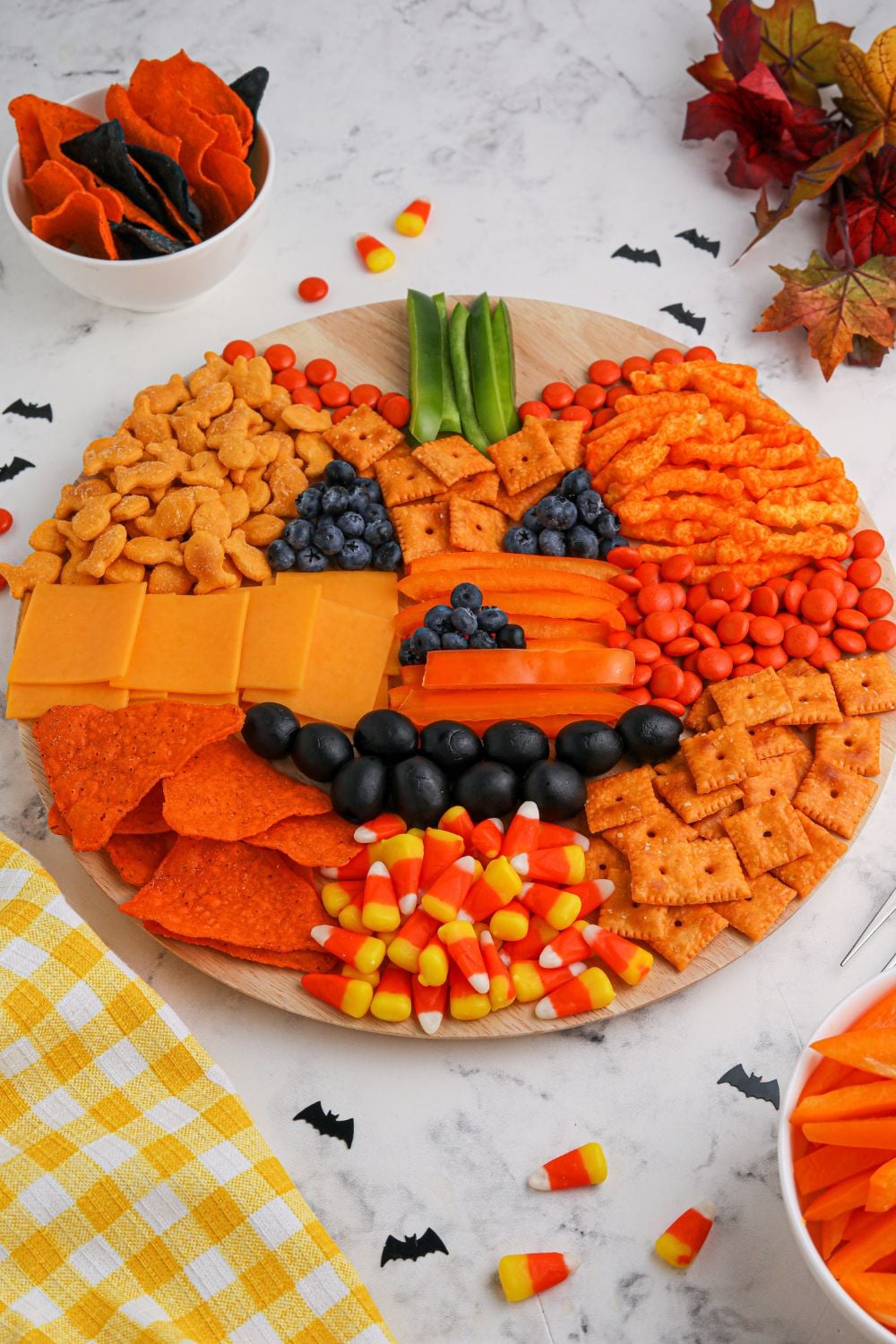 Pumpkin Charcuterie Board on table with items around it