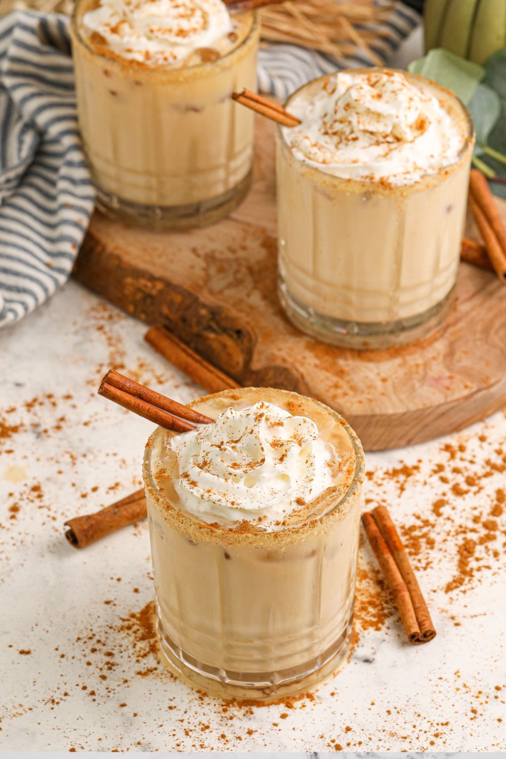 kahlua cocktails on table with cinnamon sticks around glasses on table 