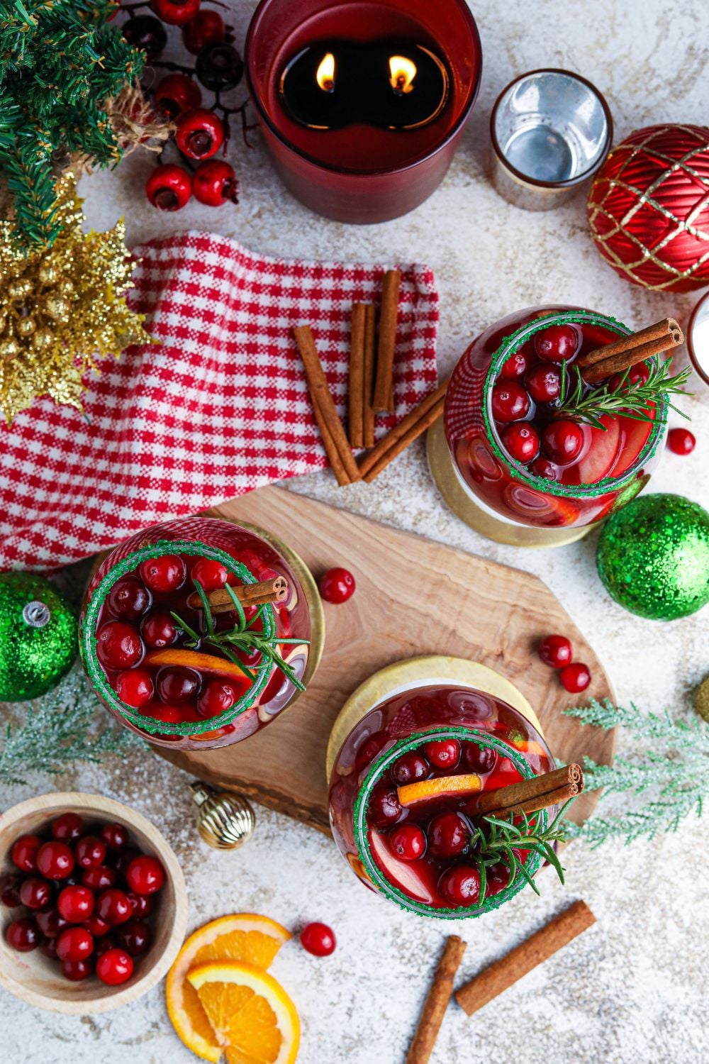 Christmas Sangria in glasses and garnishes all around it for presentation