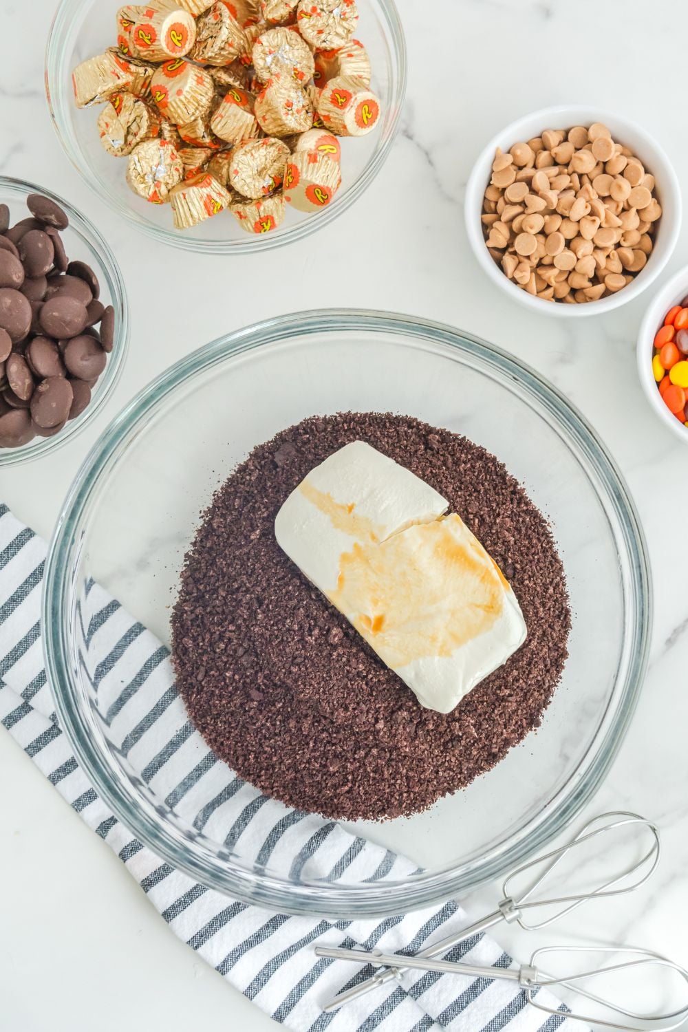 oreos crushed in bowl with cream cheese on top