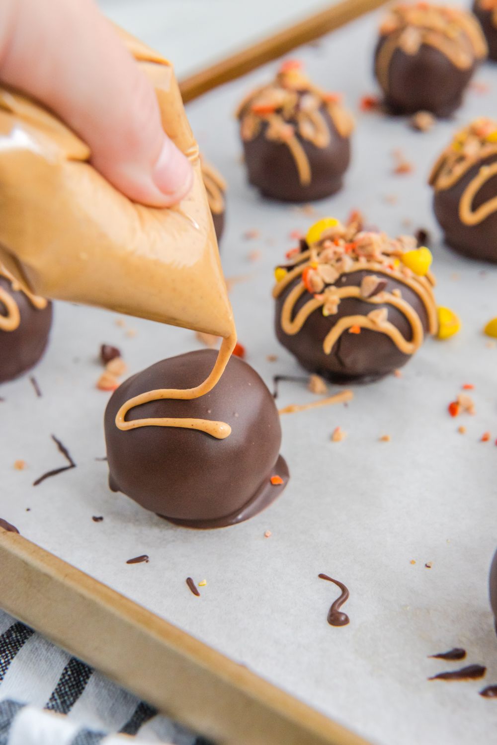 drizzling peanut butter on top of oreo balls