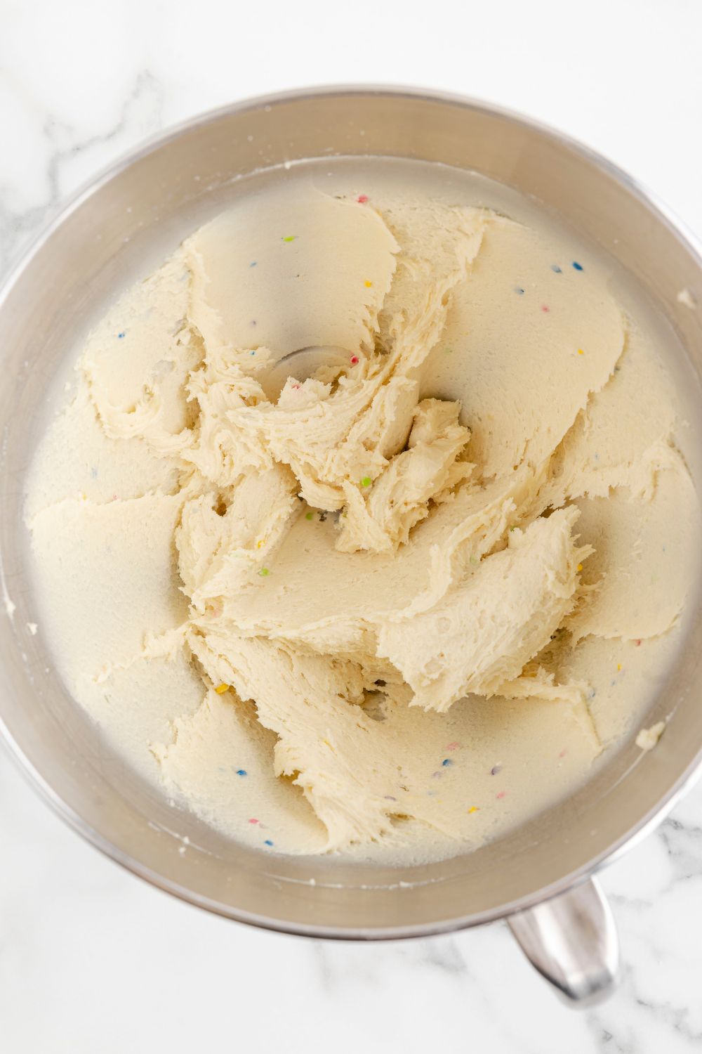 batter of sugar cookie truffles mixed in a mixing bowl