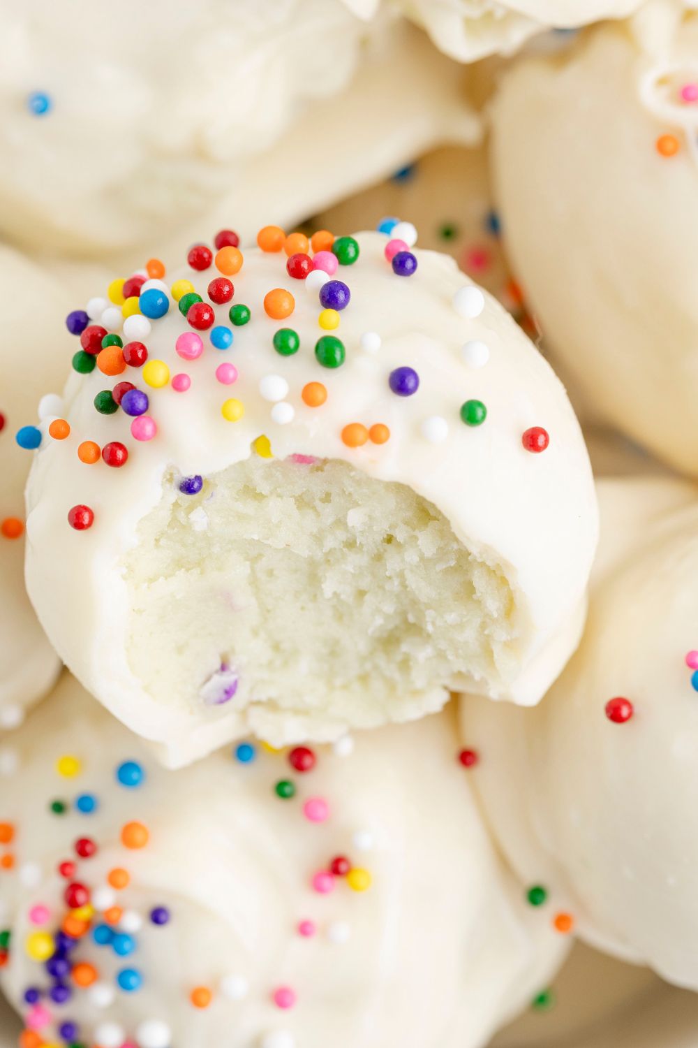 Lofthouse Sugar Cookie Truffles with a bite taken out of it 