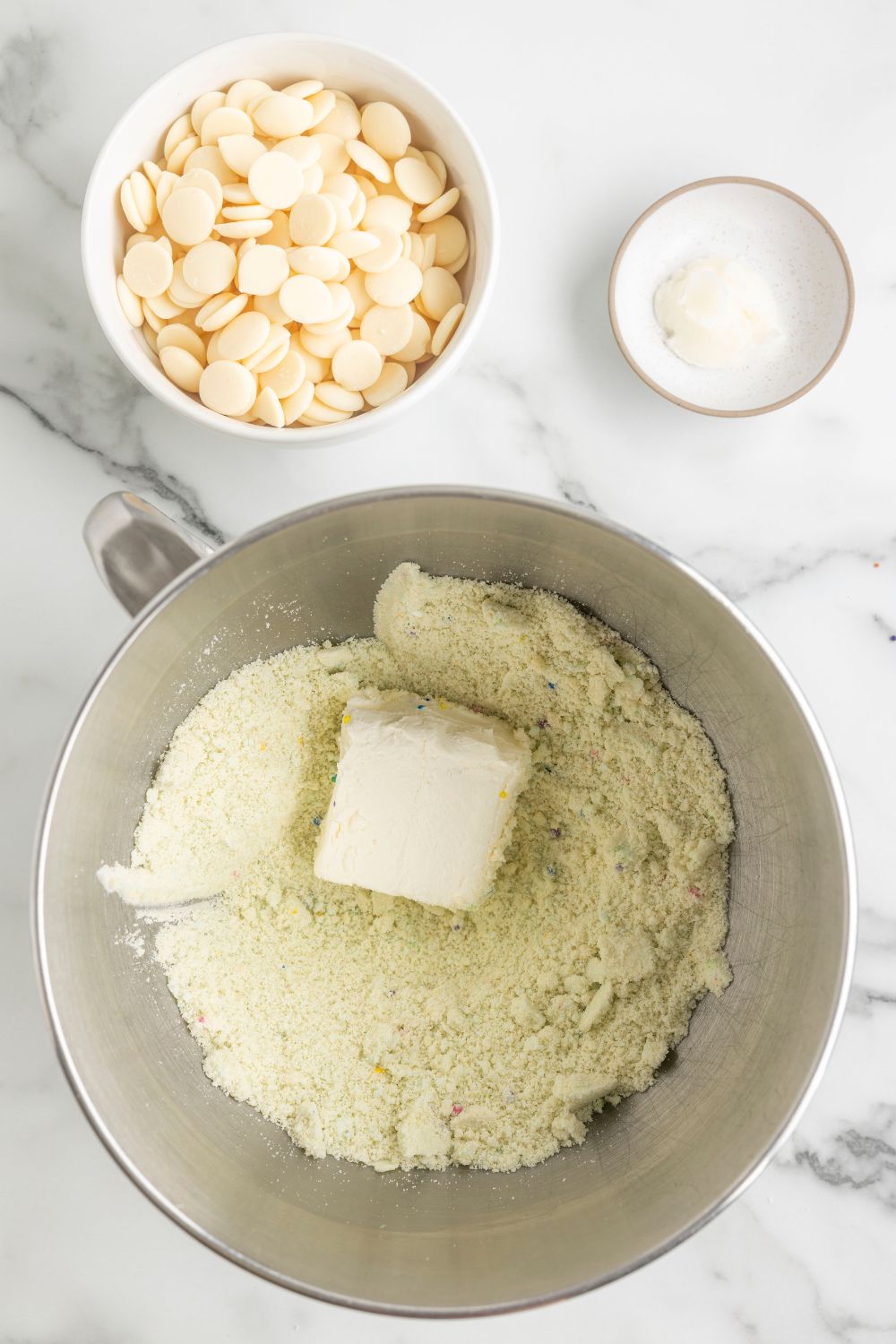 cream cheese in a bowl with sugar cookie dough 