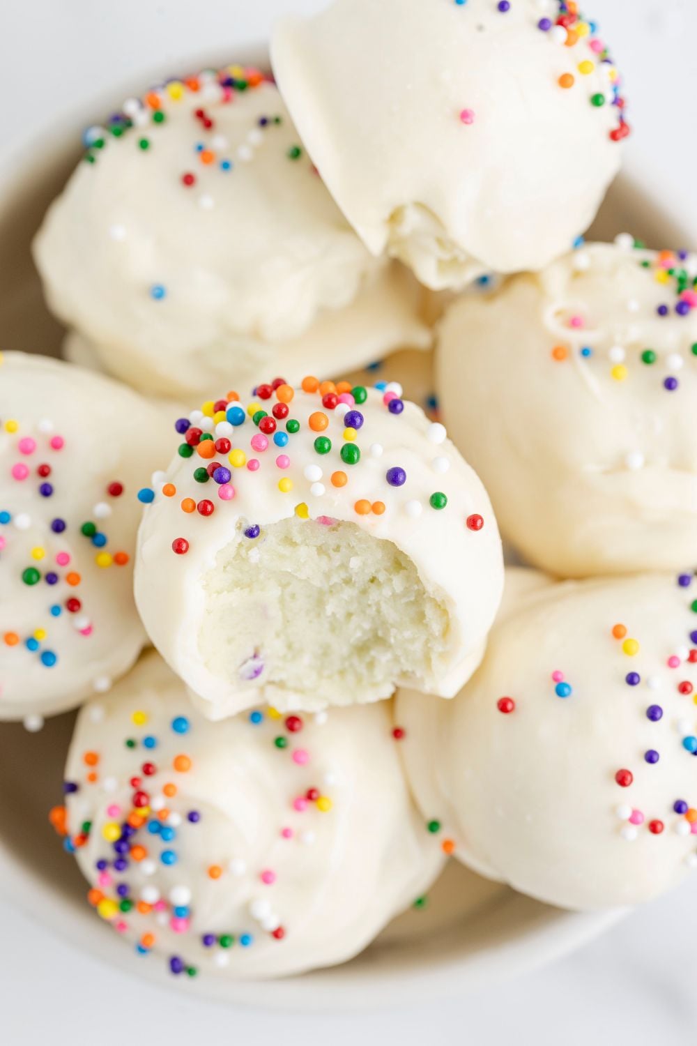 sugar cookie truffles in a white bowl on table