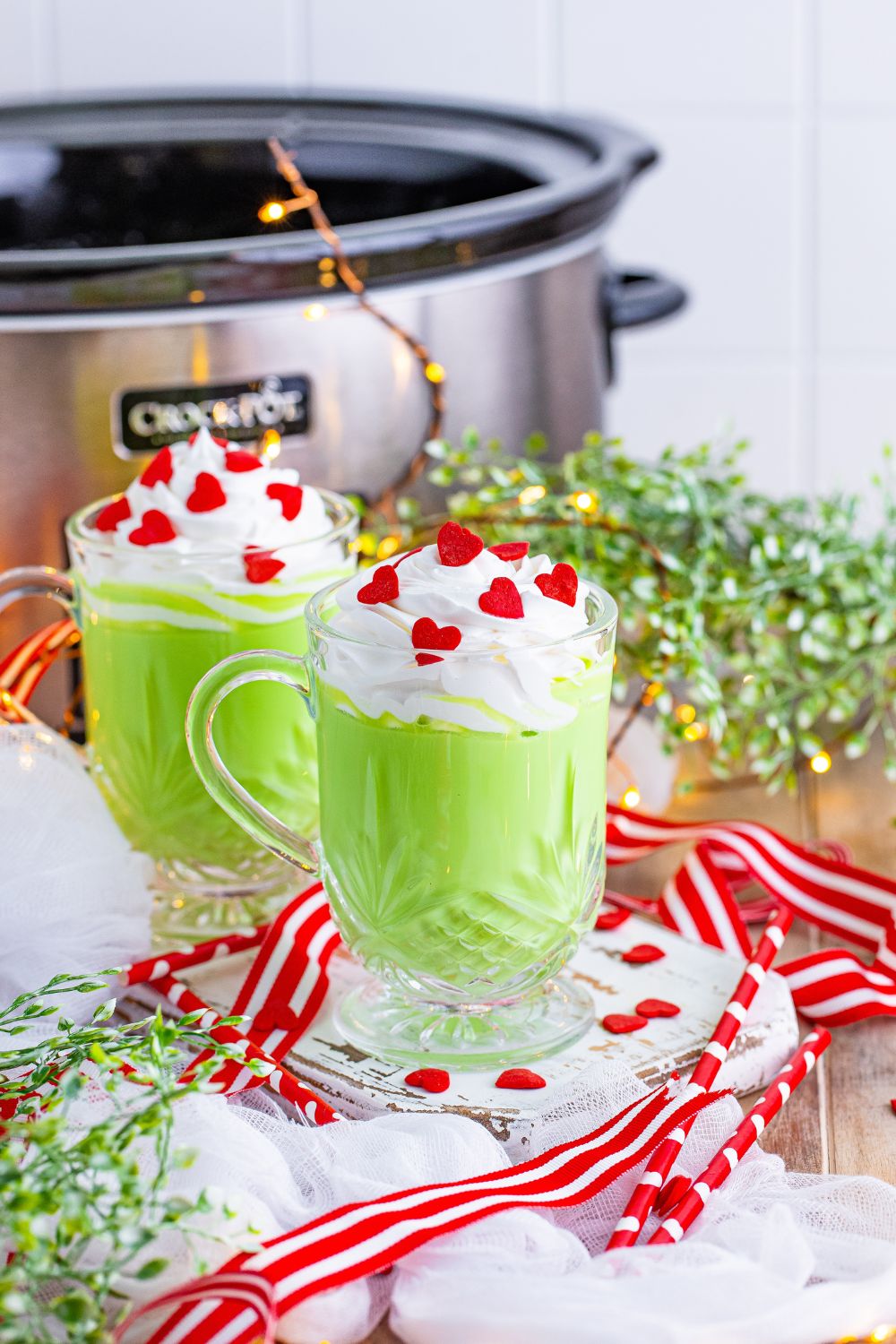 the grinch green colored hot chocolate on table with slow cooker in background