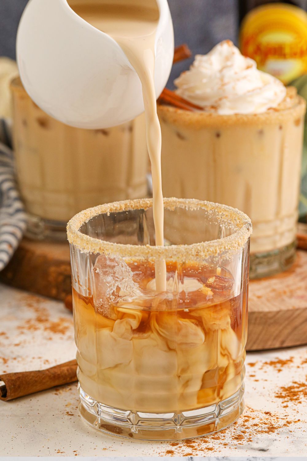 pouring kahlua into white russian drink