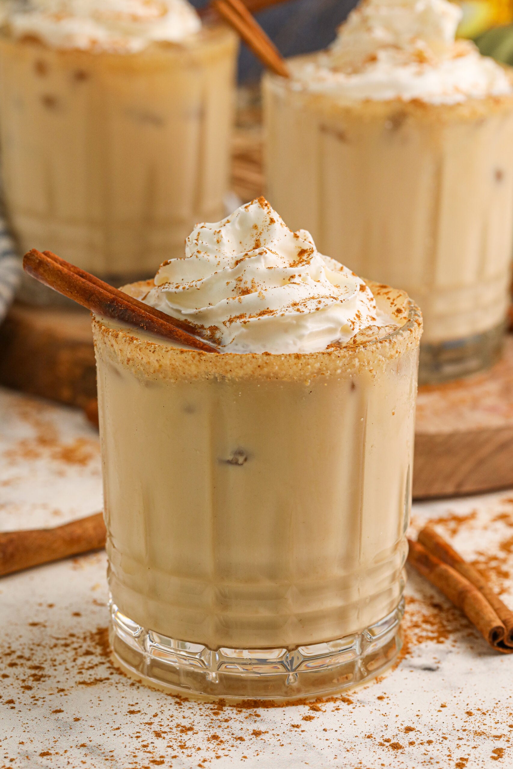 pumpkin white russian cocktail in a glass on a white table 