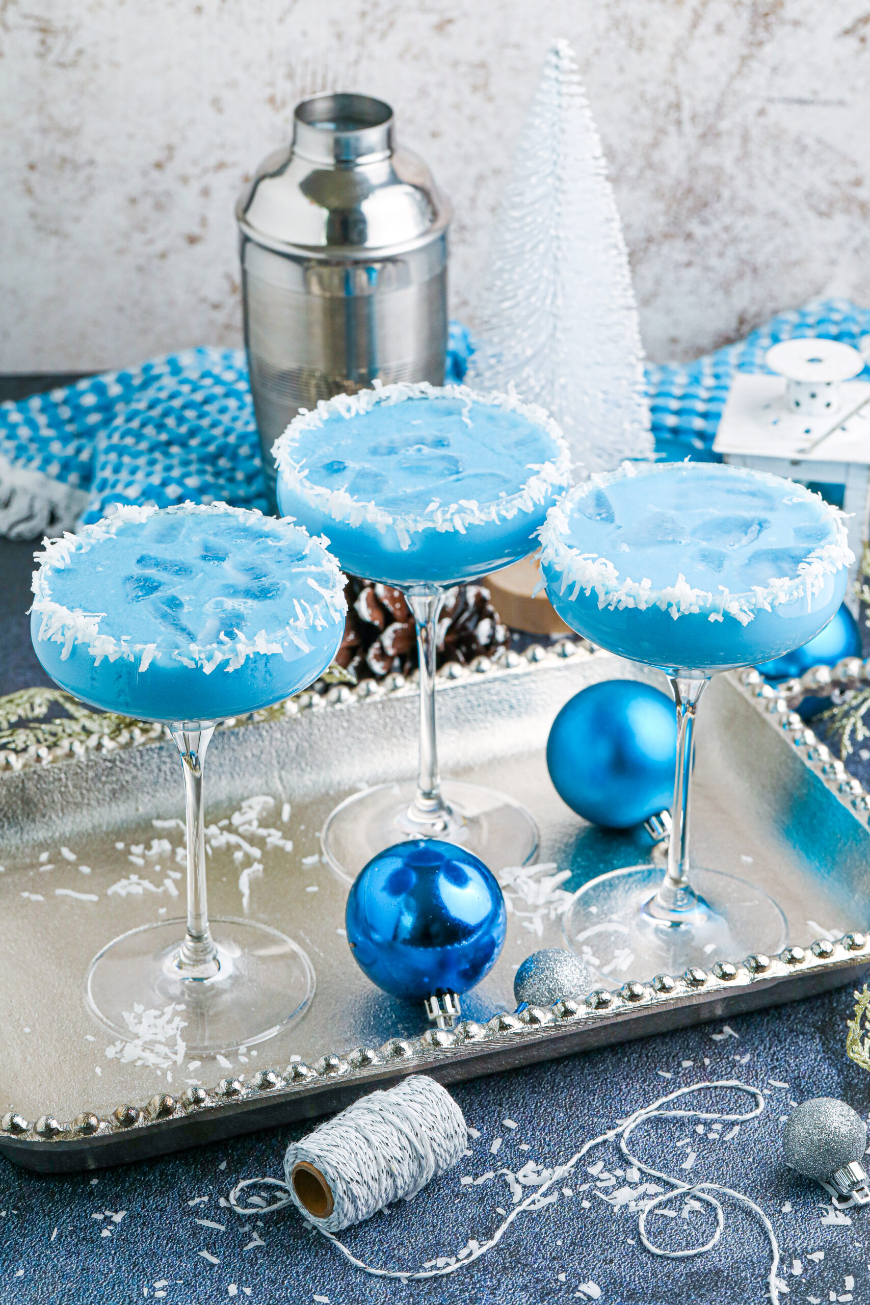 3 glasses of the blue Christmas cocktail on a silver platter 