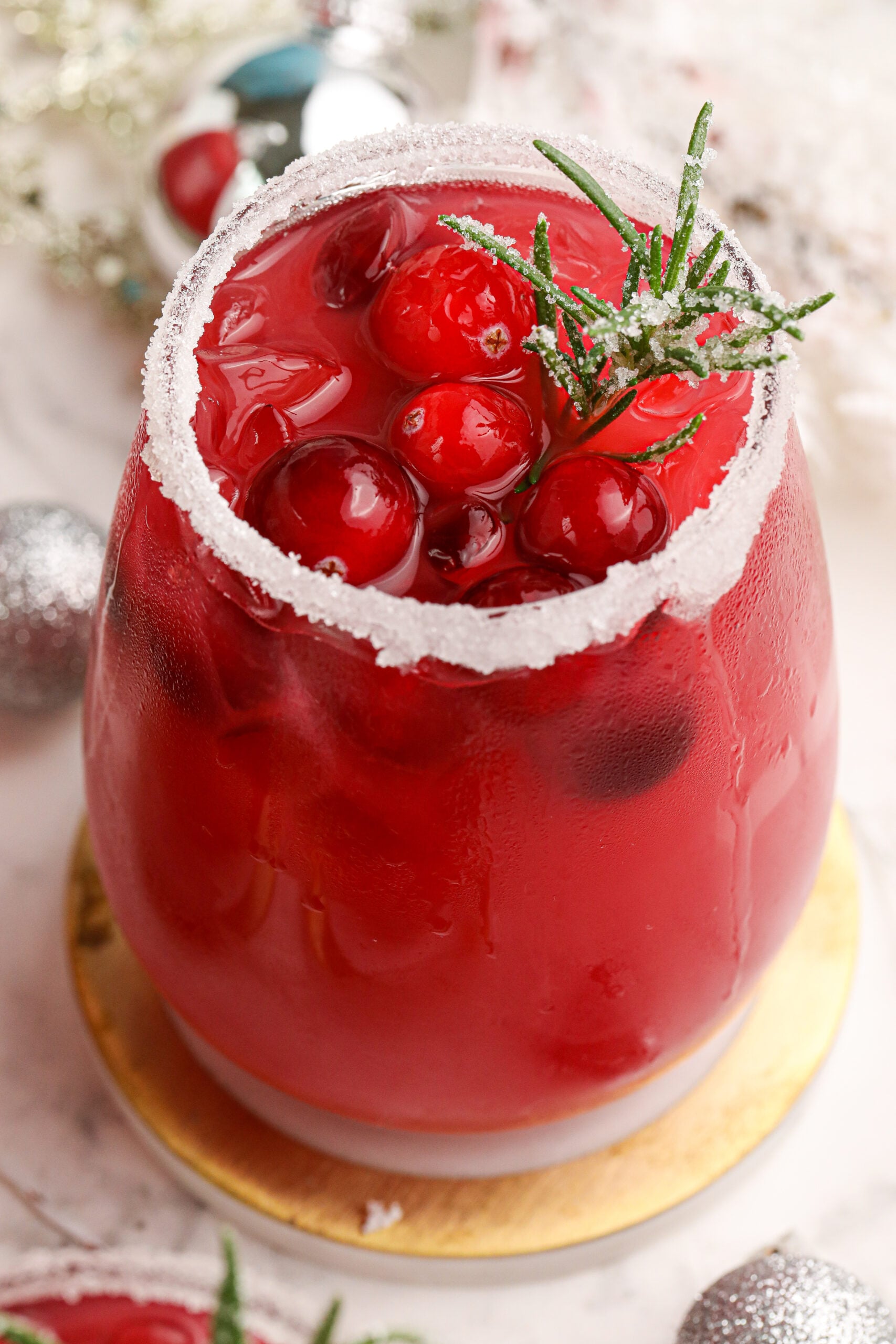 Mistletoe Margarita up close with a white sugar rim with cranberries 