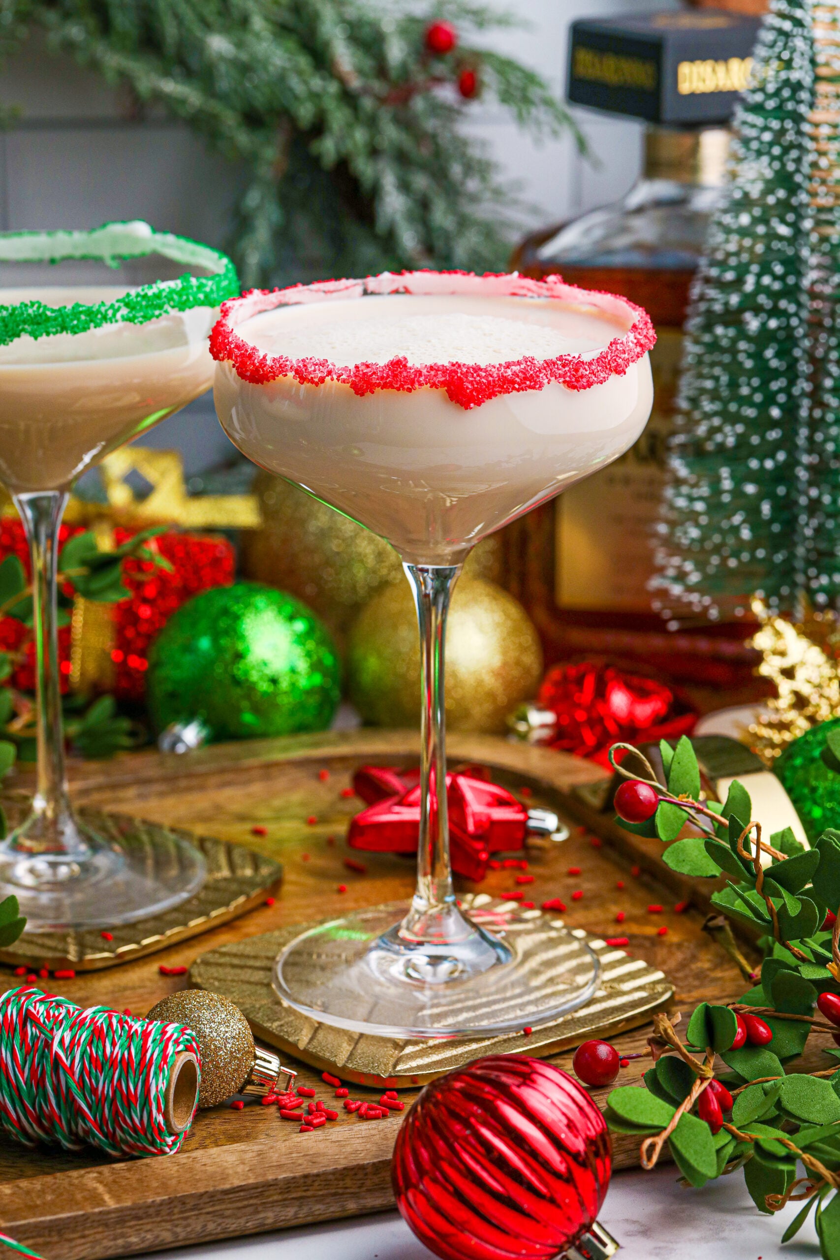 Sugar Cookie Cocktail in a glass with a red sugar rim on a wooden table 