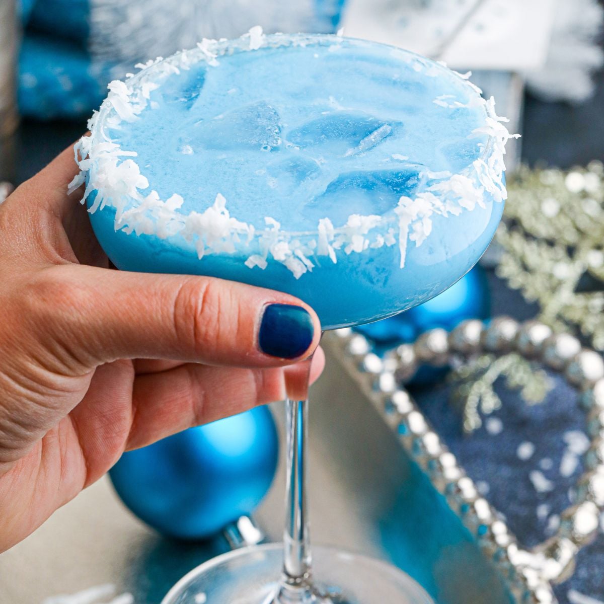 Blue Christmas Cocktail in hand 