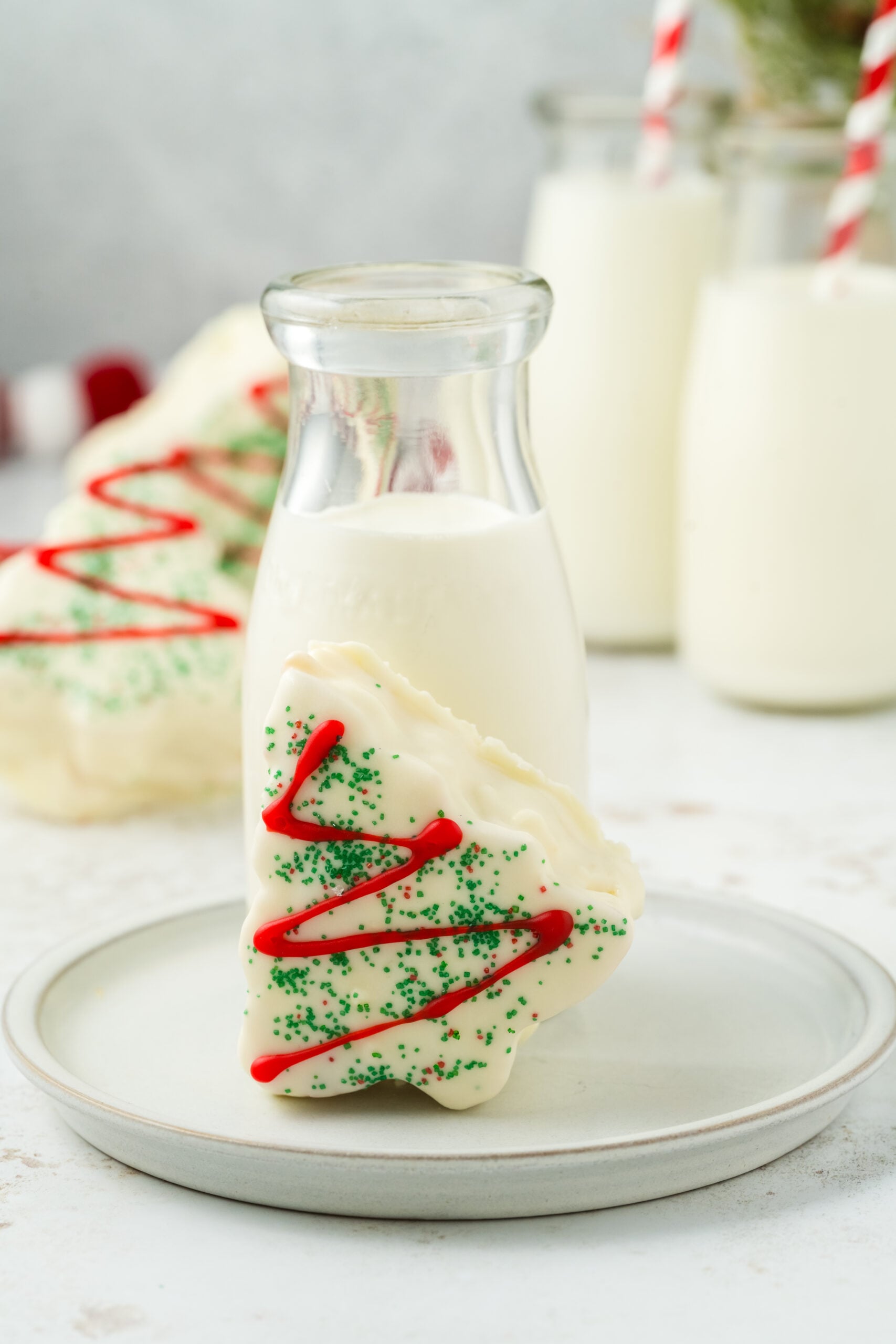 Copycat Little Debbie Christmas Tree Cake on a plate with glass of milk behind it