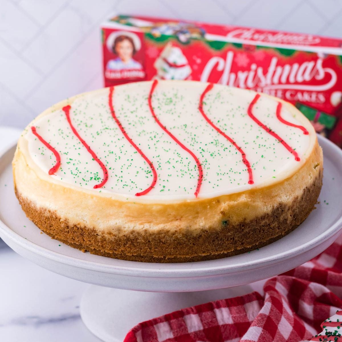 Little Debbie Christmas Tree Cheesecake on a cake platter on table 