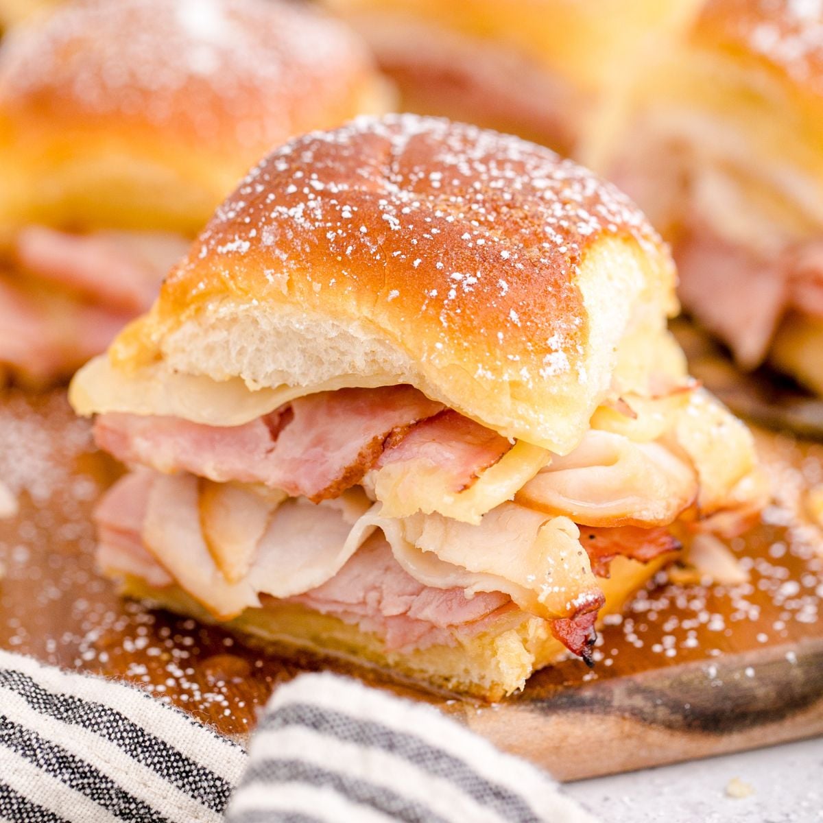 Monte Cristo Sliders on a wooden cutting board