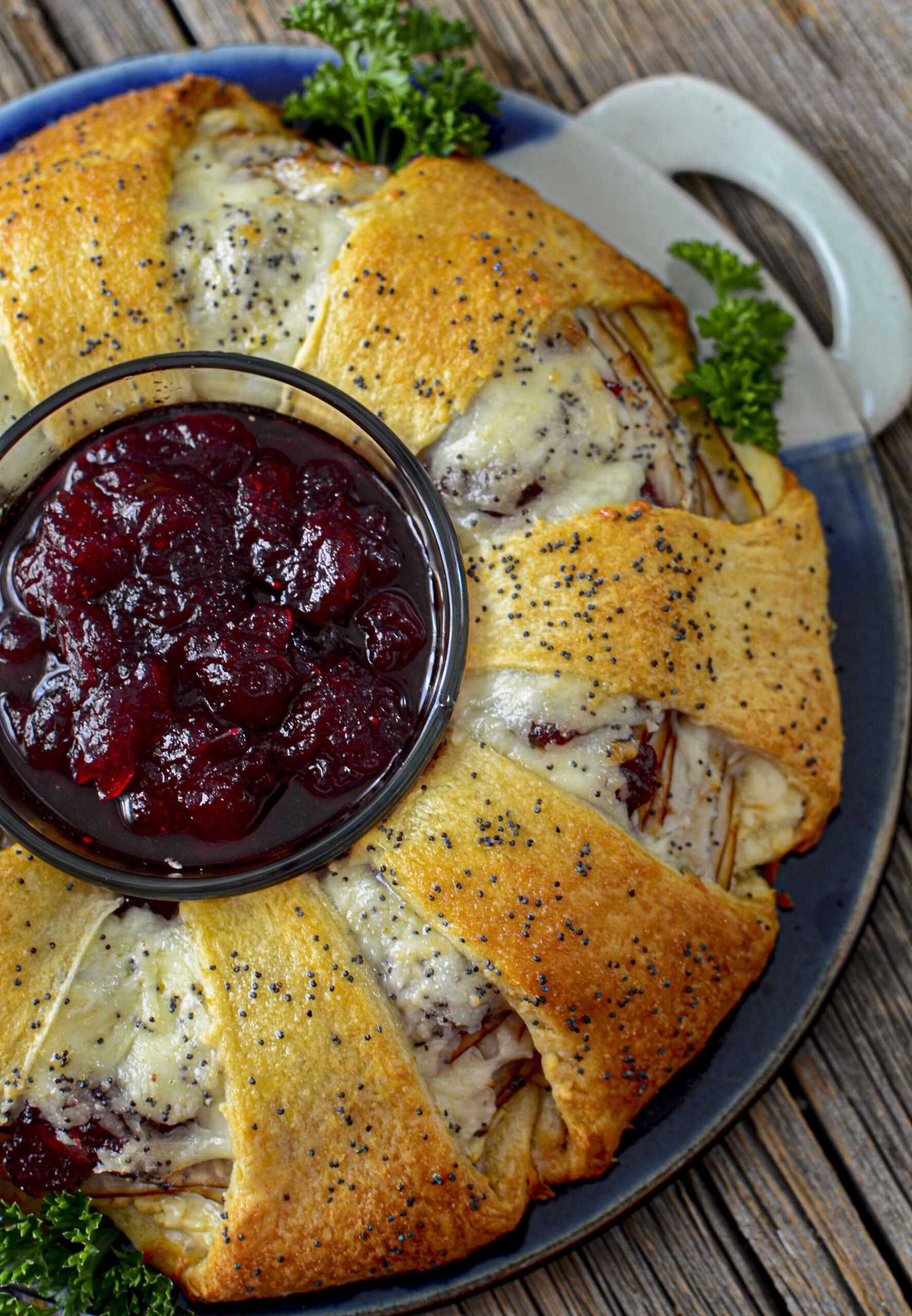 Turkey Crescent Roll Ring over head shot with a bowl of cranberry sauce in the center