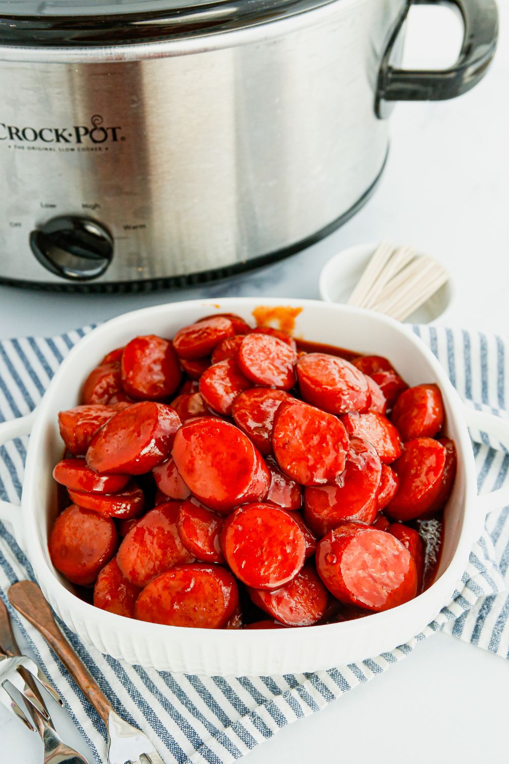 bowl with kielbasa by crockpot on table