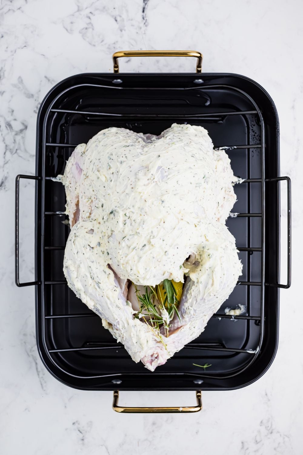 butterball turkey slathered with butter in a roasting pan
