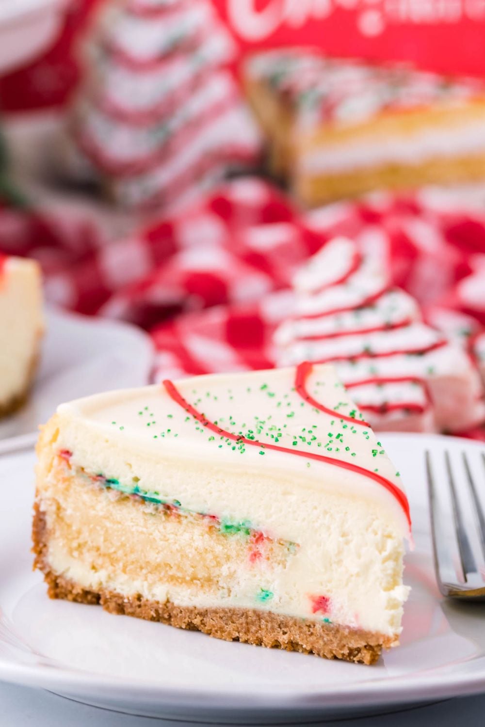 CHristmas tree Little Debbies flavored slice of cheesecake on plate with fork by it 