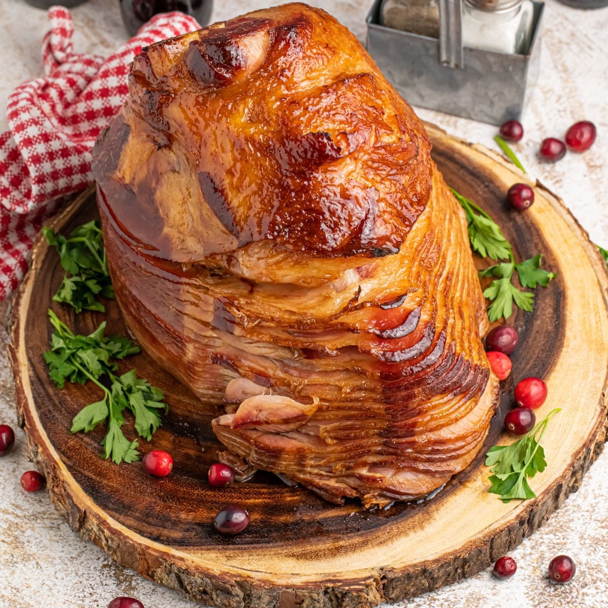 Coca Cola Ham on a wooden platter with garnish around it