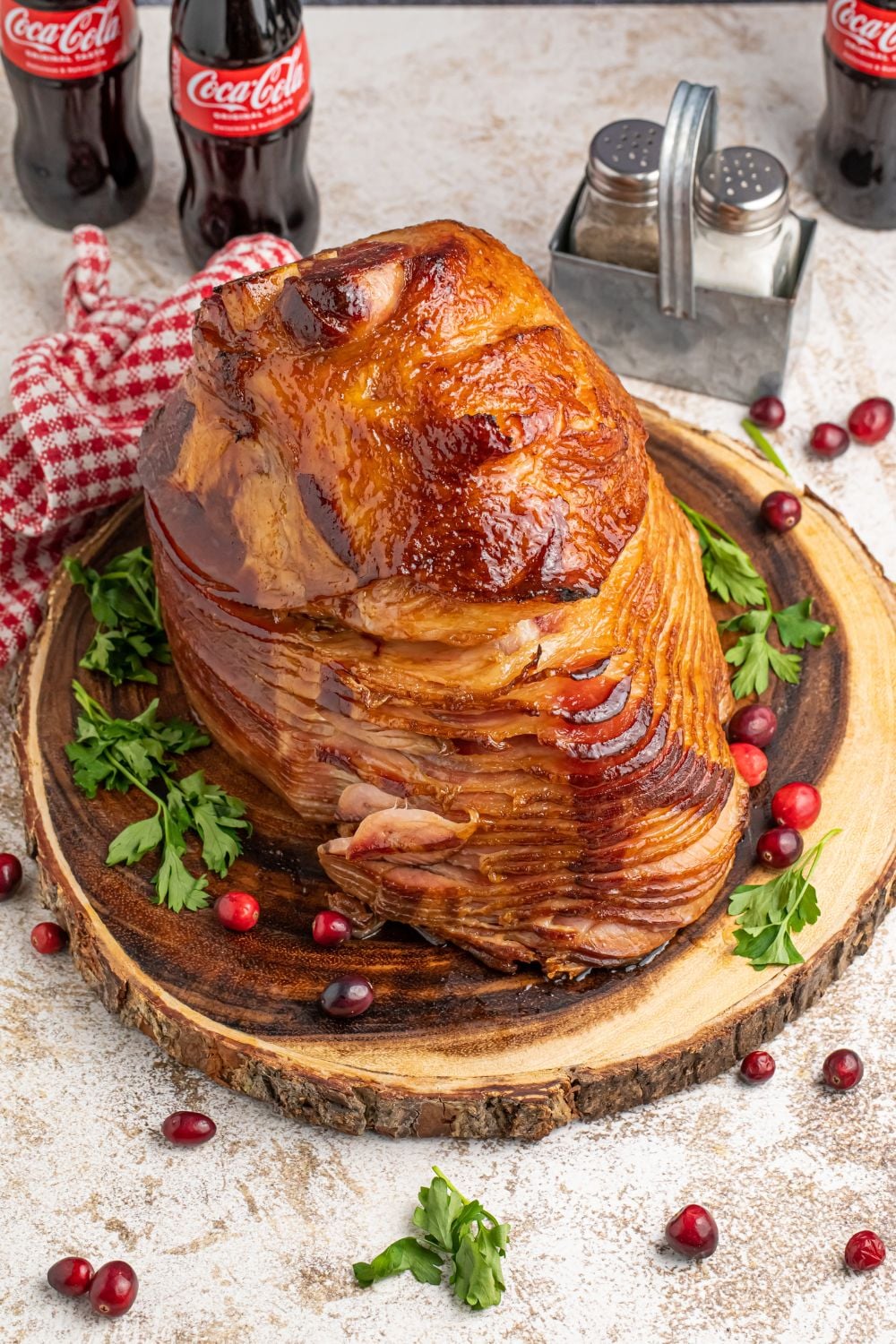 side overhead view of ham on platter with cranberries around the platter