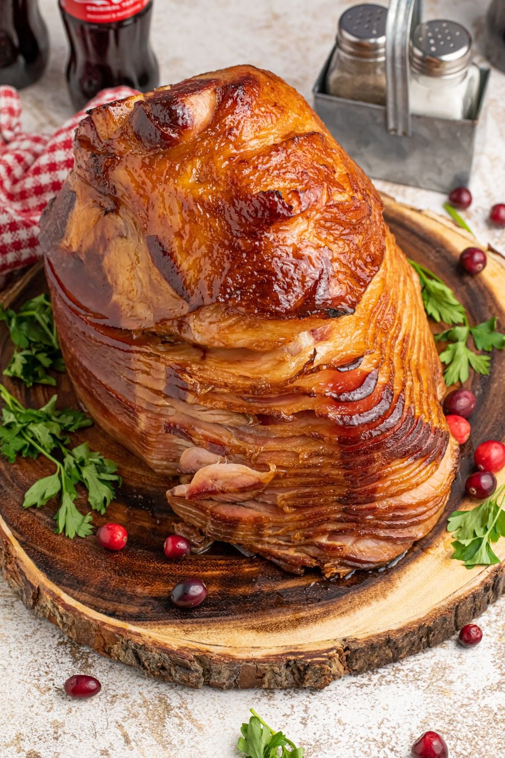 spiral cut ham displayed on platter with garnishes around it
