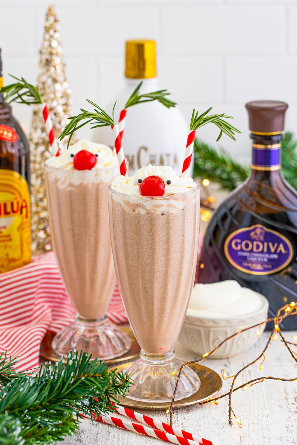 drunken rudolph drinks in glasses with ingredients and decorations around it on table