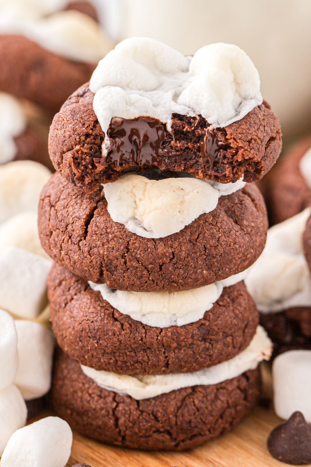 stacked cookies on table with top cookie having a bite taken out of it