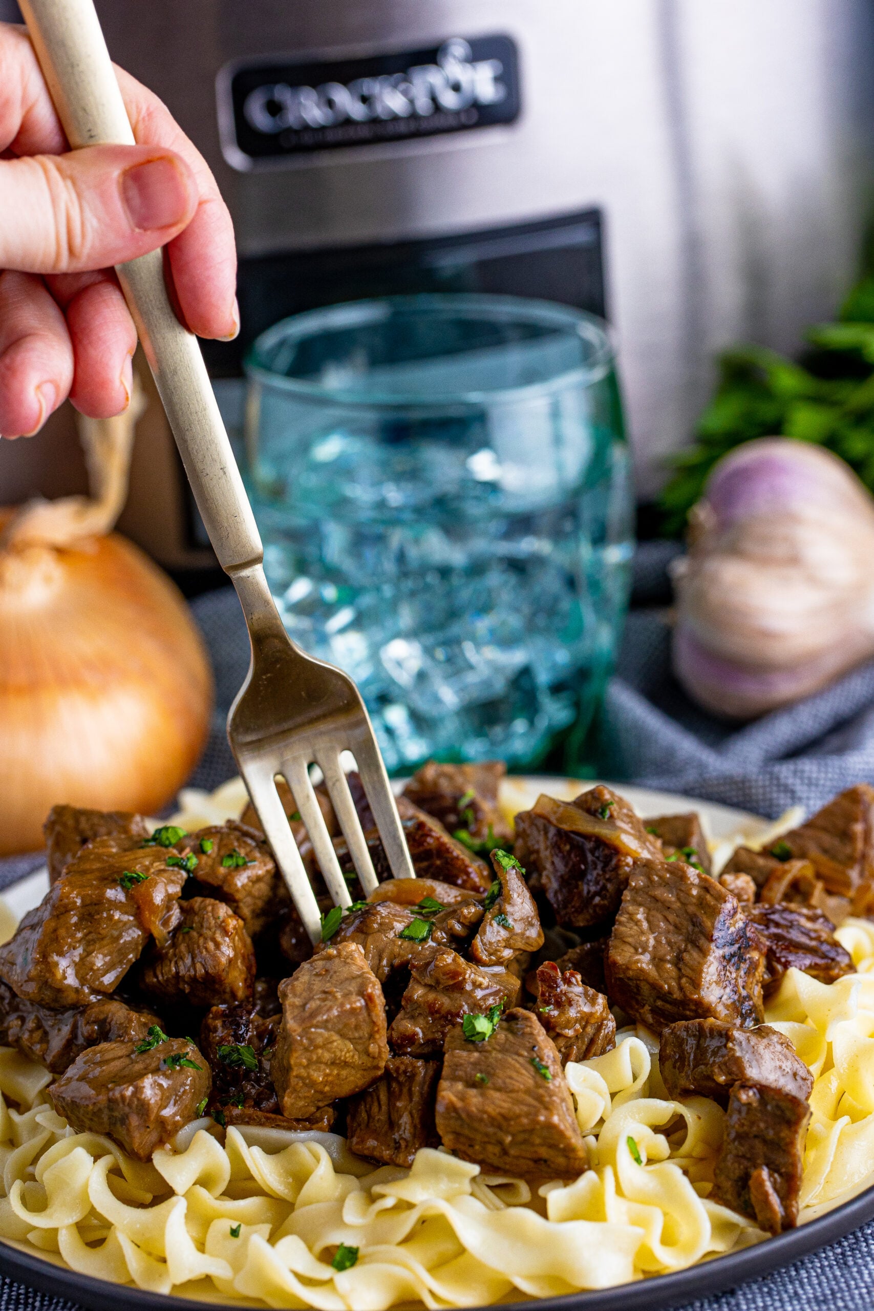 fork poking into steak bites on plate