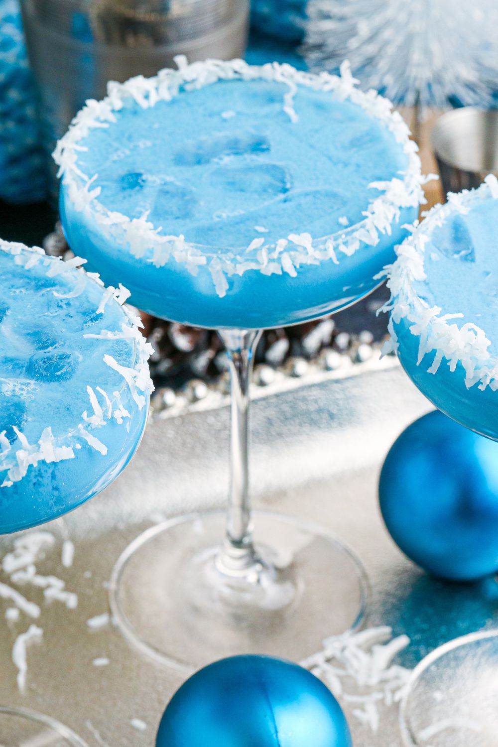 glasses on platter with blue cocktail in them 