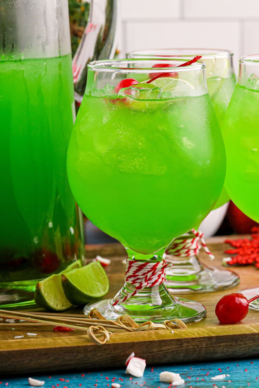 cocktail glasses full of a green punch on a wooden cutting board