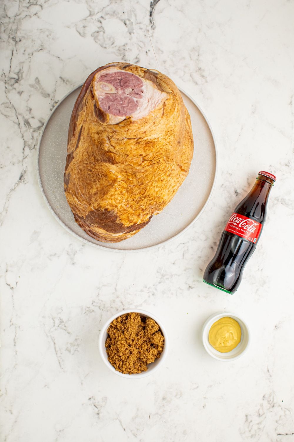 ham on plate with ingredients around it in small bowls