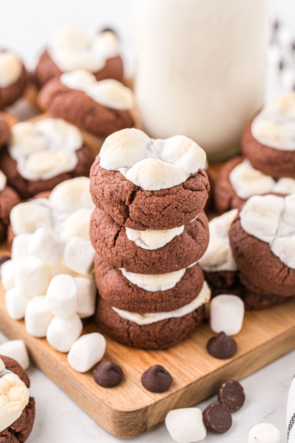 view of cookies on table with glass of milk behind it on table