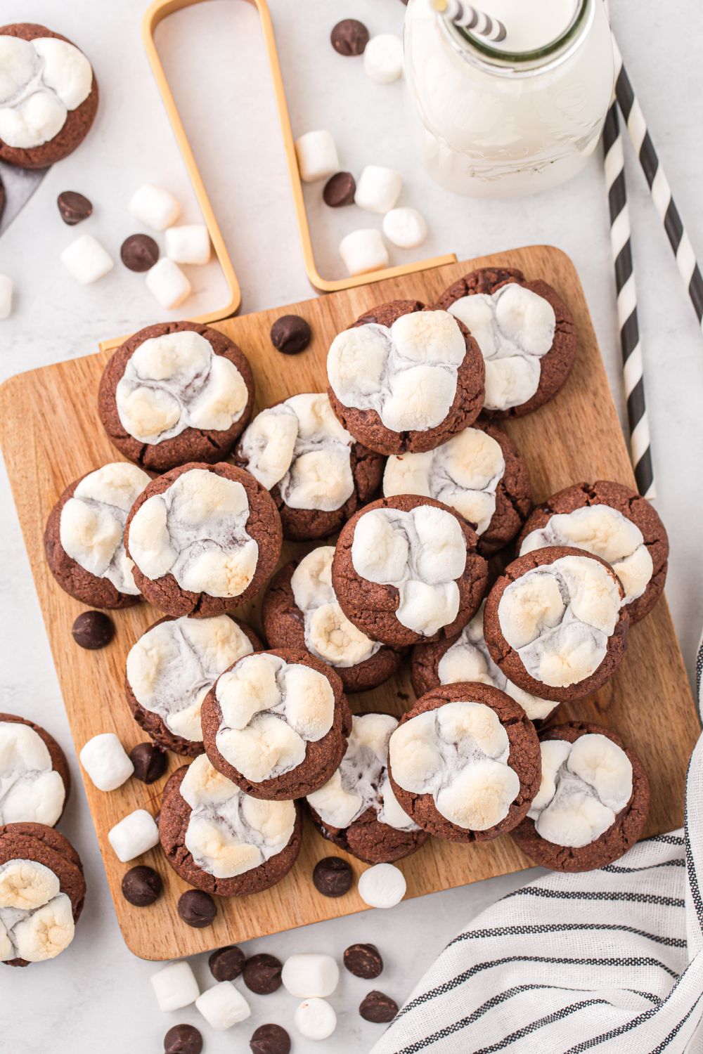 wooden cutting board on table with cookies stacked on top of each other