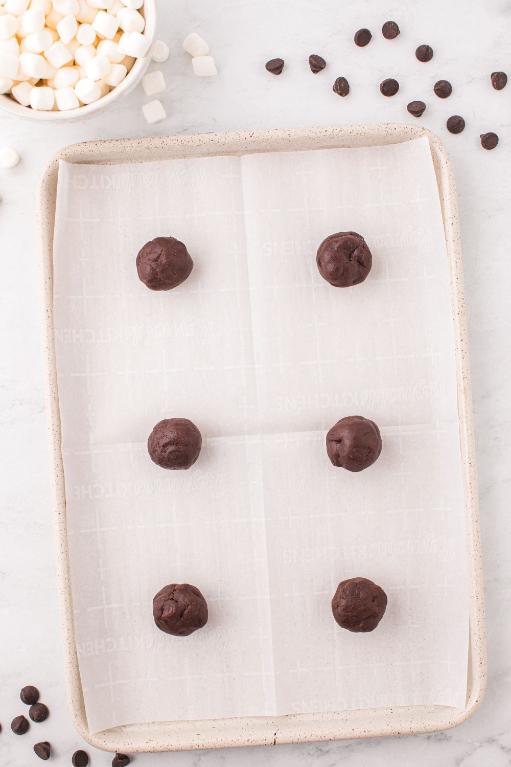 raw cookie dough balls on a pan