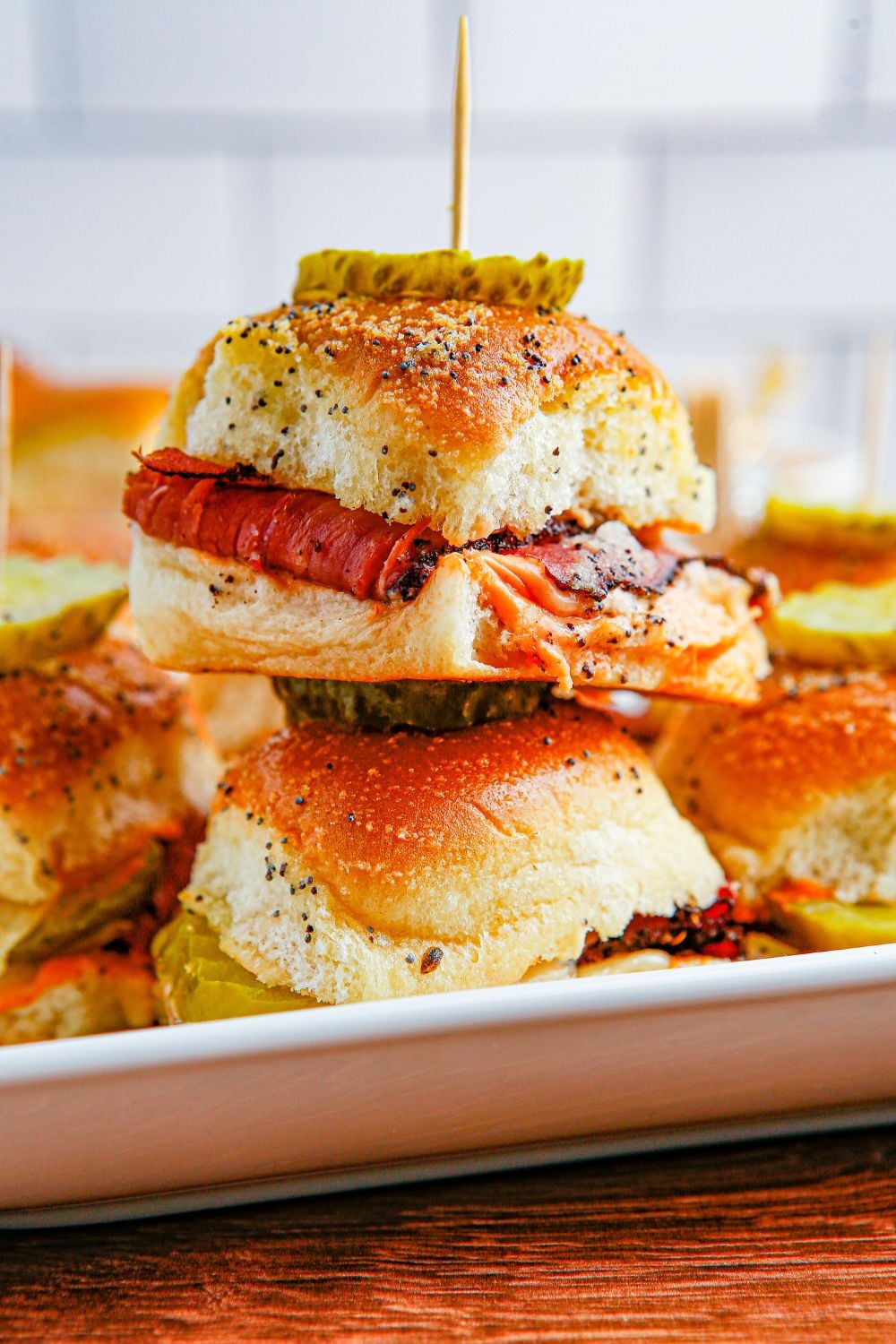 Pastrami Sliders on a white square platter on table
