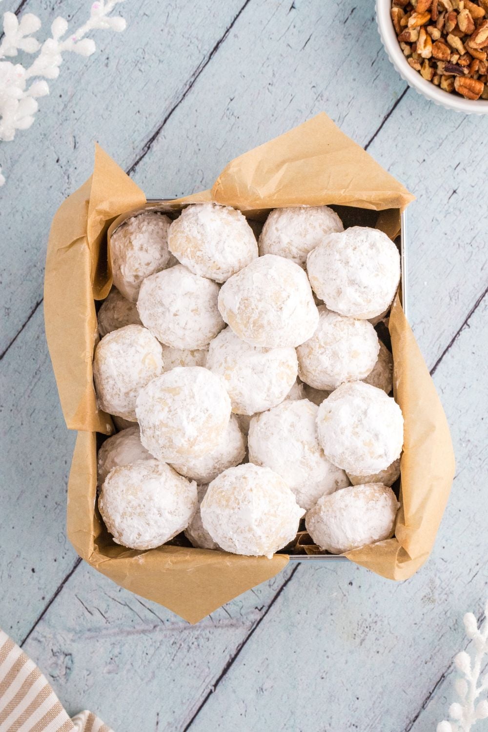italian snowball cookies in a cookie box on table