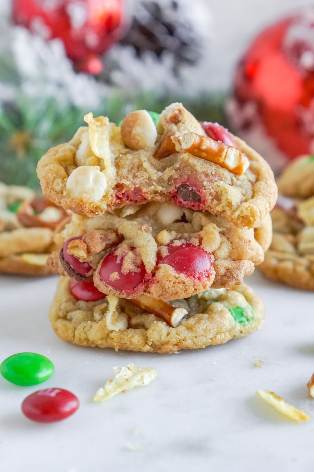 kitchen sink cookies stacked on top of each other with Christmas decorations behind it