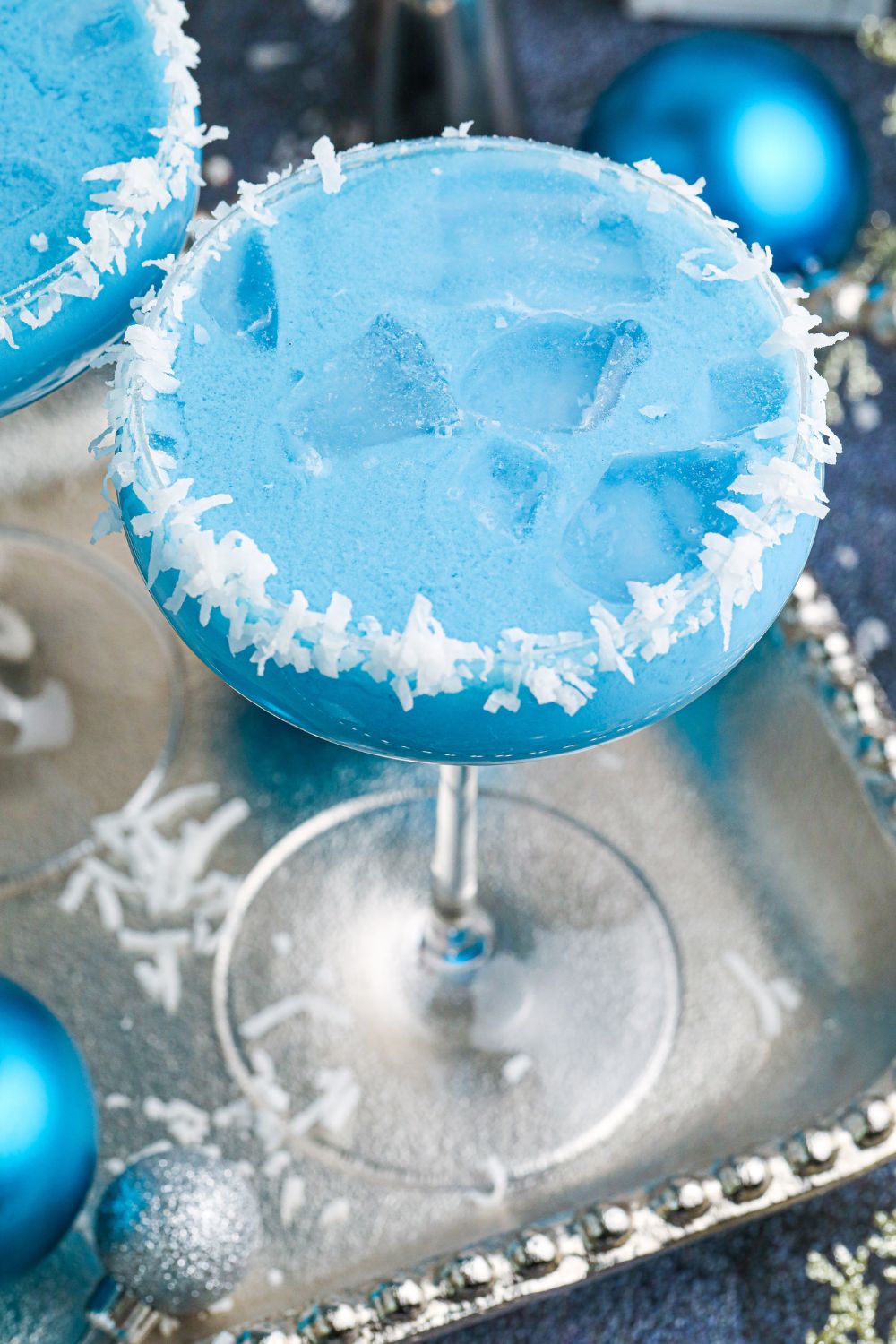 side view of blue drink on a silver platter 