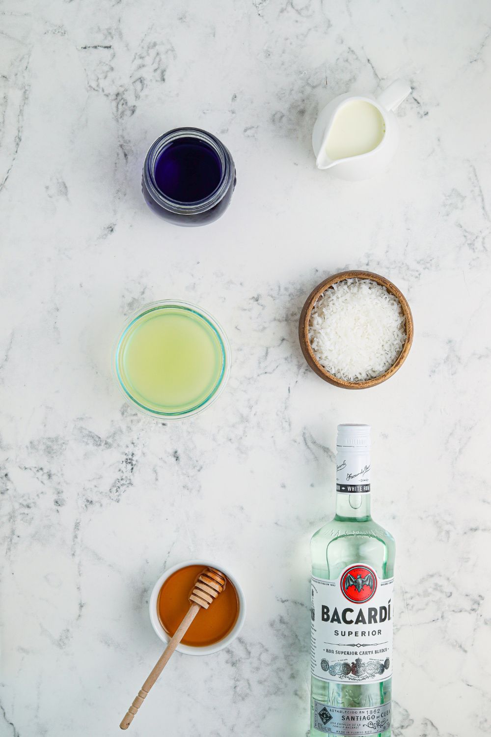 ingredients for cocktail in glass bowls on table
