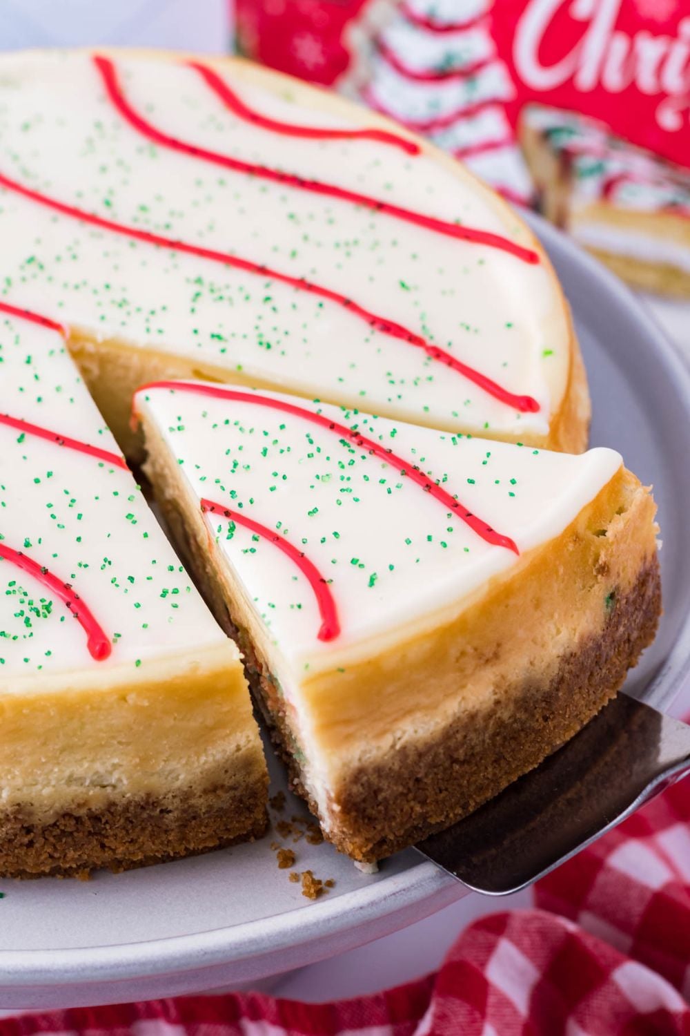 taking a slice of cheesecake out of platter 