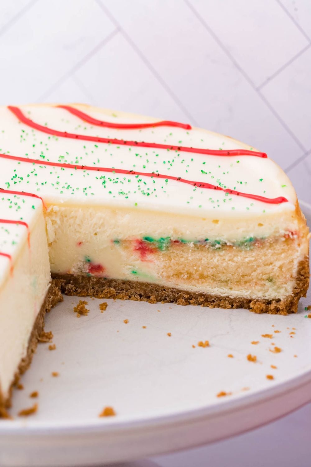 Little Debbie Christmas Tree Cheesecake with a few slices cut out on platter 