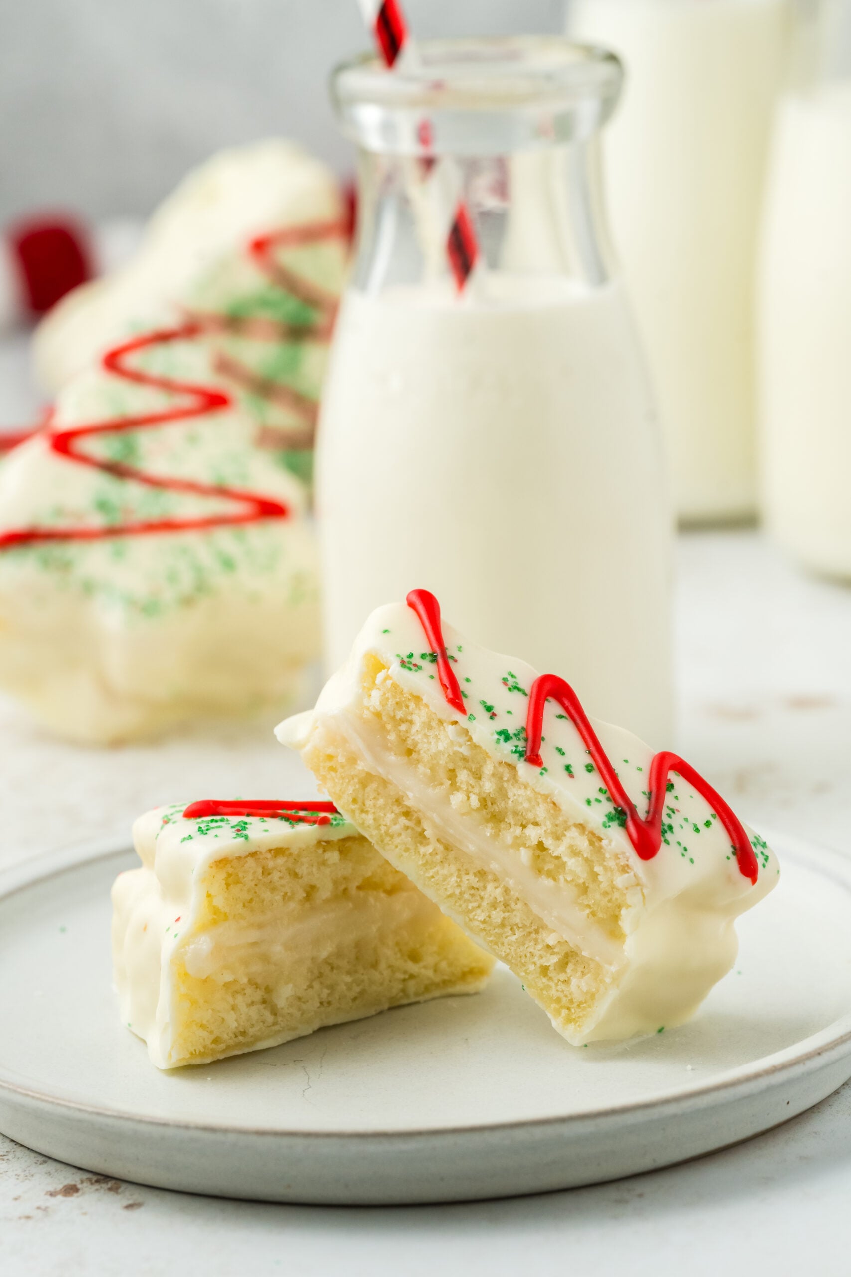 little debbies christmas tree cake cut in half on plate