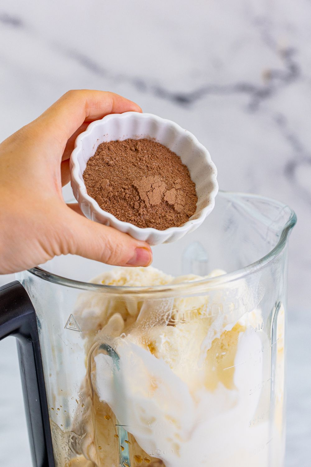 adding hot chocolate mix into bledner