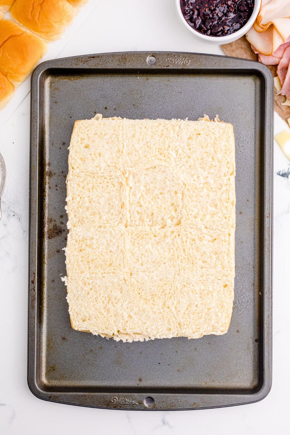 sliced sliders on a baking tray on table