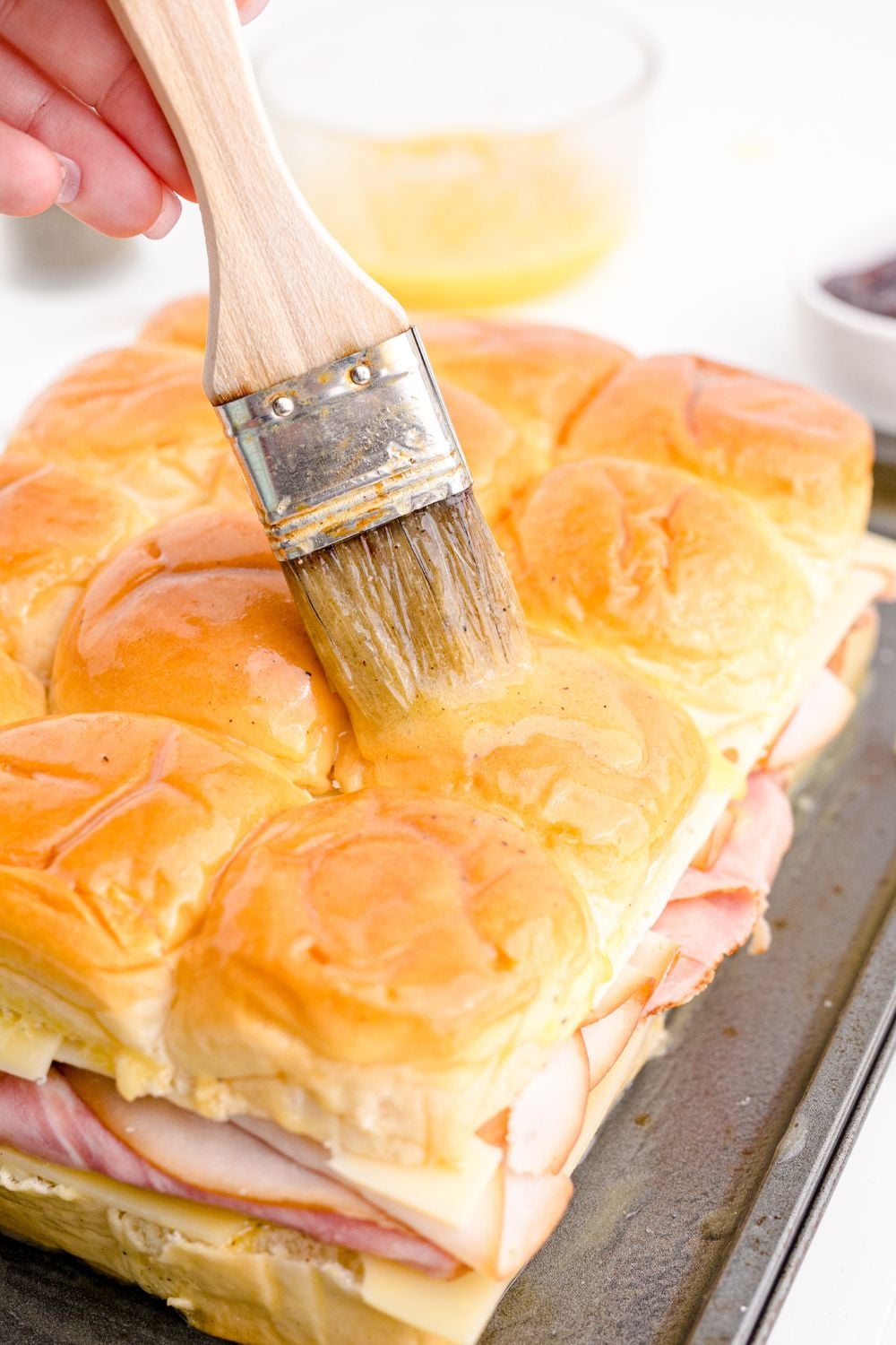 brushing top of buns with butter mixture