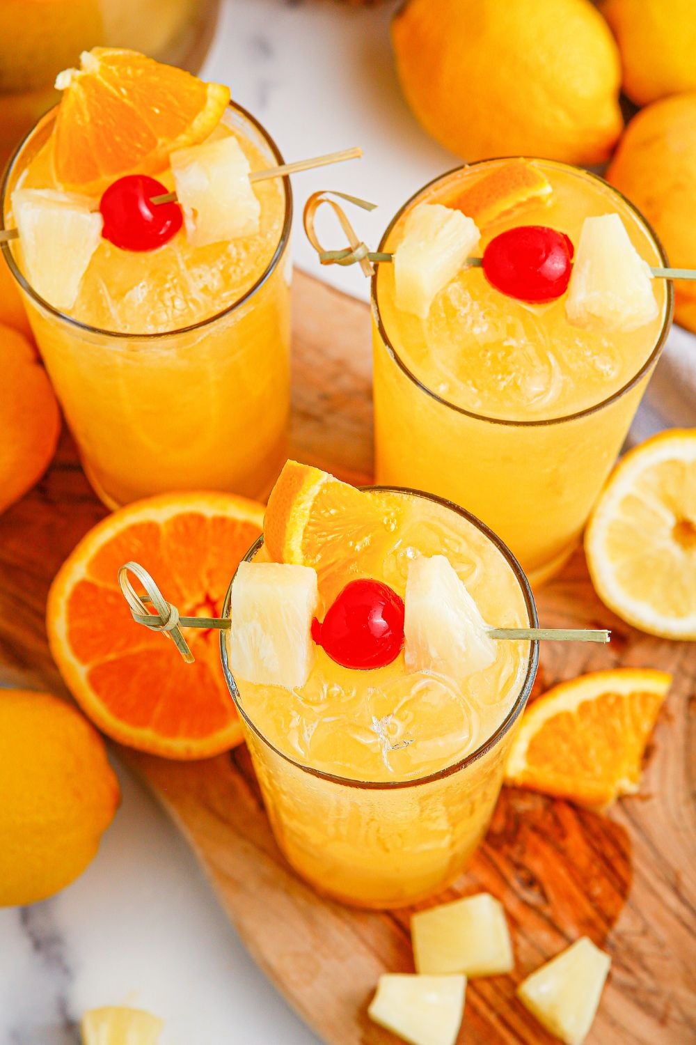 glasses with punch in them garnished with sliced fruit 