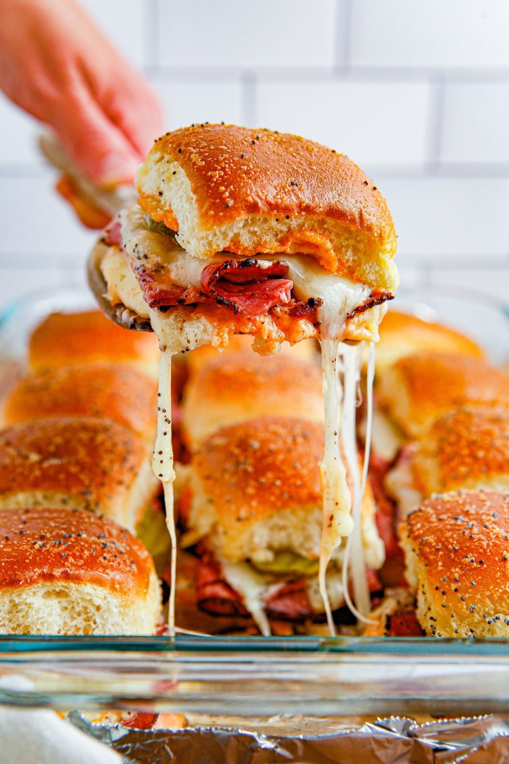 cheesy slider pulling out of pan