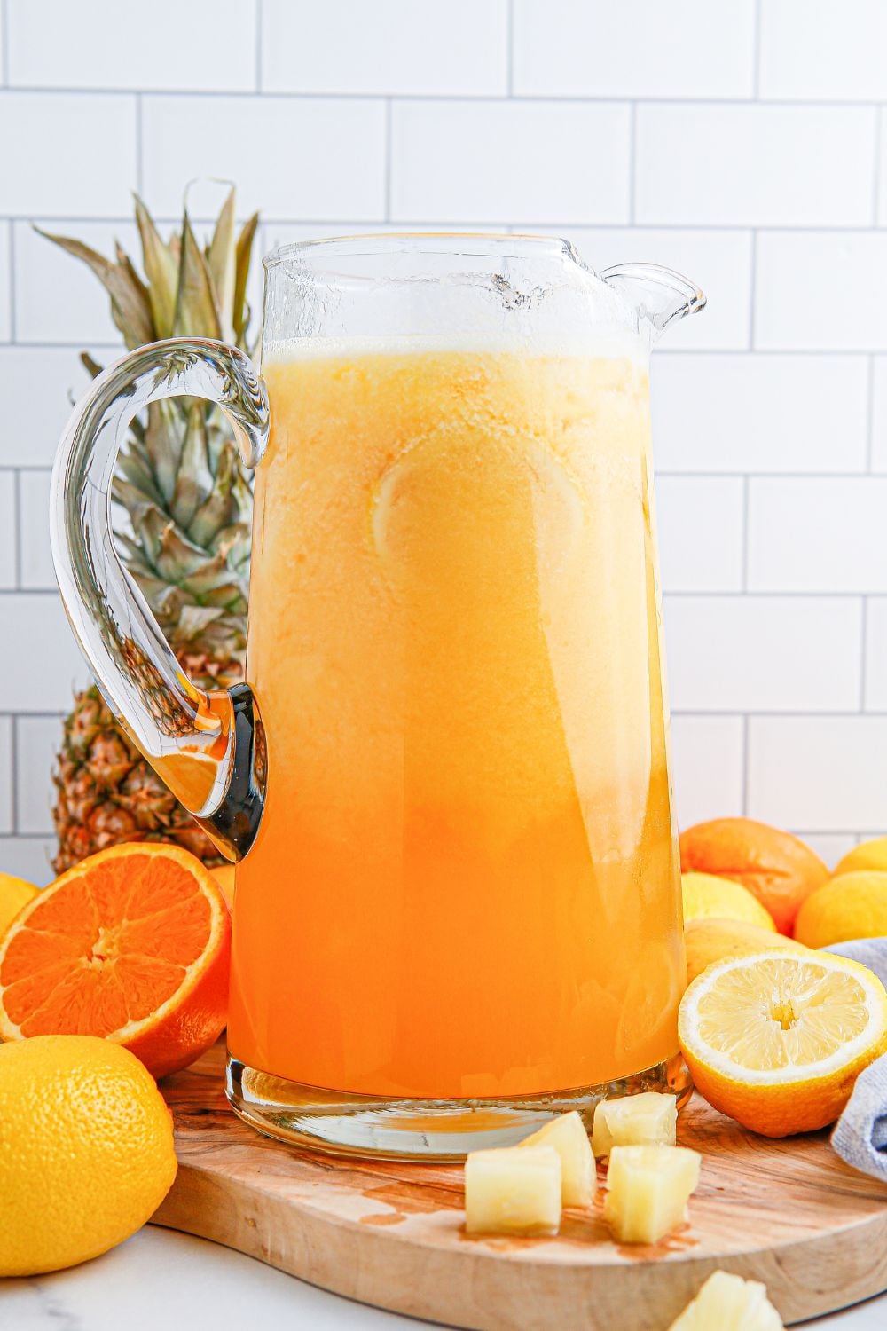 mango pineapple punch in a glass pitcher 