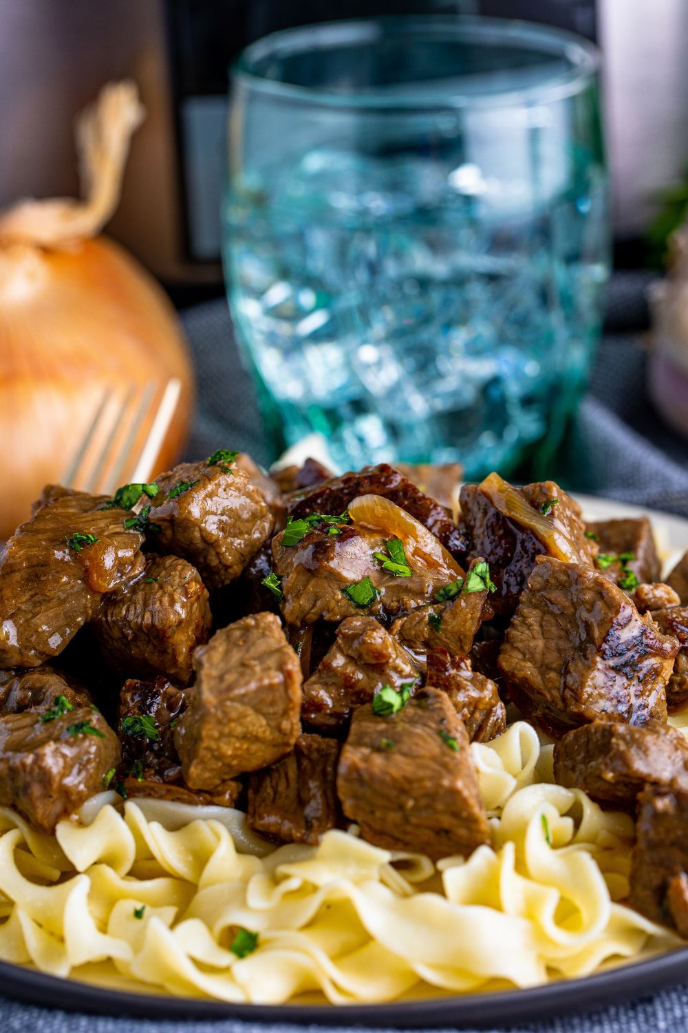 plate with steak and noodles on table